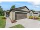 Well-maintained exterior with a concrete driveway, lovely landscaping, and a two car garage at 2821 Lytton Hall Dr, Zephyrhills, FL 33540