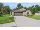 Beautiful front exterior featuring lush lawn and a two car garage at 2821 Lytton Hall Dr, Zephyrhills, FL 33540