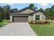 Charming single-story home with a well-manicured lawn and two car garage at 2821 Lytton Hall Dr, Zephyrhills, FL 33540