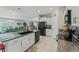 Modern kitchen with granite countertops and stainless steel appliances, adjacent to a dining area at 2821 Lytton Hall Dr, Zephyrhills, FL 33540