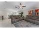 Open-concept living room with stylish sofas, area rug, and a view of the dining area and kitchen at 2821 Lytton Hall Dr, Zephyrhills, FL 33540