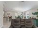 Open living space with a view of the kitchen, dining room and an exit at 2821 Lytton Hall Dr, Zephyrhills, FL 33540