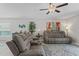 Bright living room featuring a comfortable sofa, stylish decor, and a decorative rug at 2821 Lytton Hall Dr, Zephyrhills, FL 33540