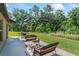 Outdoor patio includes a table and chair seating arrangement with picturesque views of green foliage at 2821 Lytton Hall Dr, Zephyrhills, FL 33540