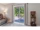 Cozy outdoor patio with dining set, sliding glass door, and tranquil view of the backyard at 2821 Lytton Hall Dr, Zephyrhills, FL 33540