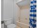 Bathroom showcasing a tub and shower with matching blue striped shower curtain and toilet at 305 Bryan Oak Ave, Brandon, FL 33511
