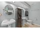 Dual-sink bathroom with modern fixtures, recessed lighting, and wood-look flooring at 305 Bryan Oak Ave, Brandon, FL 33511