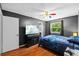 Bedroom featuring hardwood floors, ceiling fan and TV on a black entertainment center at 305 Bryan Oak Ave, Brandon, FL 33511