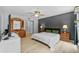 Bedroom with a dark accent wall, a ceiling fan, and two dressers; ideal for a guest room at 305 Bryan Oak Ave, Brandon, FL 33511