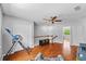 Bonus room with hardwood floors, a ceiling fan, and a staircase leading to the second floor at 305 Bryan Oak Ave, Brandon, FL 33511