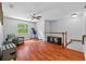 Large bonus room featuring hardwood floors, a ceiling fan, and a large window overlooking the backyard at 305 Bryan Oak Ave, Brandon, FL 33511