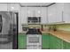 Modern kitchen featuring stainless steel appliances, granite countertops, and ample cabinet space at 305 Bryan Oak Ave, Brandon, FL 33511