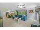 Cozy living room with kitchen view, hardwood floors, and easy access to outdoor pool at 305 Bryan Oak Ave, Brandon, FL 33511