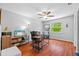 Home office with a large window, a ceiling fan, a desk, and hardwood floors at 305 Bryan Oak Ave, Brandon, FL 33511