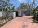 View of backyard with white fence, side door, and small outdoor space at 310 79Th Ave, St Pete Beach, FL 33706