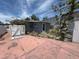 View of backyard with white fence, side door, and small outdoor space at 310 79Th Ave, St Pete Beach, FL 33706