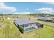 Aerial view of the home featuring a screened pool and sprawling green backyard at 32860 Drake Estates Way, Dade City, FL 33525