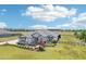 An aerial view of a beautiful home with lush lawns, well-manicured landscaping, and a private driveway at 32860 Drake Estates Way, Dade City, FL 33525