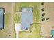 Aerial view showing a backyard pool, screened in, and an oversized lot with a modern home and beautiful landscaping at 32860 Drake Estates Way, Dade City, FL 33525