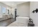 Luxurious bathroom with a soaking tub, walk-in shower, and dual vanities, providing a serene and spa-like atmosphere at 32860 Drake Estates Way, Dade City, FL 33525