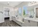 Bright bathroom with dual vanities, large windows, and modern fixtures, offering a spa-like experience at 32860 Drake Estates Way, Dade City, FL 33525