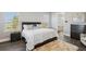 Inviting bedroom with plush rug, dark wood furniture, and a view of the bathroom, creating a cozy retreat at 32860 Drake Estates Way, Dade City, FL 33525