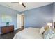 Comfortable bedroom features wood floors, a ceiling fan and soft blue walls at 32860 Drake Estates Way, Dade City, FL 33525