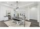 Dining room with decorative rug, bar with wine rack, and modern farmhouse-style table at 32860 Drake Estates Way, Dade City, FL 33525