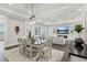 Dining room with rug, modern farmhouse-style table, and view to the open concept living room at 32860 Drake Estates Way, Dade City, FL 33525