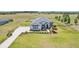 The home features beautiful landscaping, a long driveway, and a lush green yard with fencing at 32860 Drake Estates Way, Dade City, FL 33525
