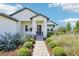 Inviting front entrance of a well-maintained home with stone accents and manicured landscaping at 32860 Drake Estates Way, Dade City, FL 33525
