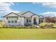 Charming one-story home featuring stone accents, manicured landscaping, and a lush green lawn at 32860 Drake Estates Way, Dade City, FL 33525