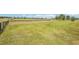 A spacious, grassy lot featuring picturesque views and a classic wooden fence at 32860 Drake Estates Way, Dade City, FL 33525