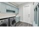 Laundry room features modern appliances and custom blue storage cabinets at 32860 Drake Estates Way, Dade City, FL 33525