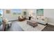 Comfortable living room with a patterned rug, neutral-toned furnishings, and a large window at 32860 Drake Estates Way, Dade City, FL 33525