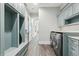 Mud room with laundry hookups, custom blue storage cabinets and hall at 32860 Drake Estates Way, Dade City, FL 33525