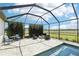 Enjoy the outdoors with a fire pit and dining area in the screened-in lanai next to the beautiful pool and spa at 32860 Drake Estates Way, Dade City, FL 33525