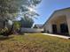 Expansive backyard with mature trees, vinyl and wooden fencing and an intriguing rockery at 3414 Berry Blossom Ln, Plant City, FL 33567