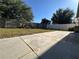 Spacious backyard with a patio area, privacy fence, and mature trees for shade at 3414 Berry Blossom Ln, Plant City, FL 33567