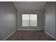 Spacious bedroom featuring neutral walls, a window with blinds and a built-in shelving unit at 3414 Berry Blossom Ln, Plant City, FL 33567