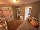 Comfortable bedroom with soft carpet, a closet, and a peek into the bathroom at 3414 Berry Blossom Ln, Plant City, FL 33567