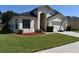 Charming home with a well-maintained lawn and appealing landscaping details at 3414 Berry Blossom Ln, Plant City, FL 33567