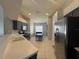 View of kitchen with stainless appliances, modern cabinetry, tile flooring and an eat-in breakfast nook at 3414 Berry Blossom Ln, Plant City, FL 33567