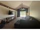 Living room with vaulted ceiling, ceiling fan, and sliding glass doors leading to outdoor space at 3414 Berry Blossom Ln, Plant City, FL 33567