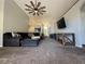 Open-concept living room with ceiling fan, media center, and neutral carpet at 3414 Berry Blossom Ln, Plant City, FL 33567