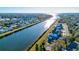 Waterfront houses along canal with lush greenery and bridge, convenient for boating at 3420 Channelside Ct, Safety Harbor, FL 34695