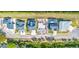 Aerial view of new home foundation between existing houses with screened in pools in a lakeside community at 3420 Channelside Ct, Safety Harbor, FL 34695