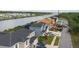 Aerial view of new construction home with water view, and adjacent homes in the community at 3420 Channelside Ct, Safety Harbor, FL 34695