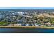 Aerial view showing lakeside homes and a new foundation with city skyline in the background at 3420 Channelside Ct, Safety Harbor, FL 34695
