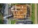 Birds eye view of a new home framing, and adjacent construction site and equipment at 3420 Channelside Ct, Safety Harbor, FL 34695